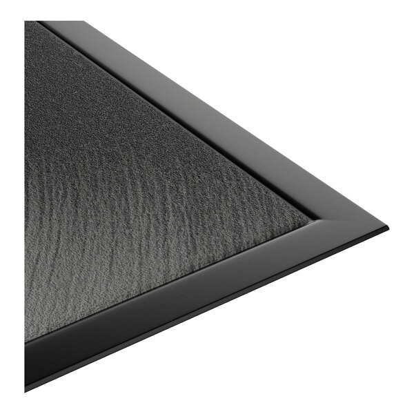 A black customizable entrance mat with a textured surface and beveled edges.