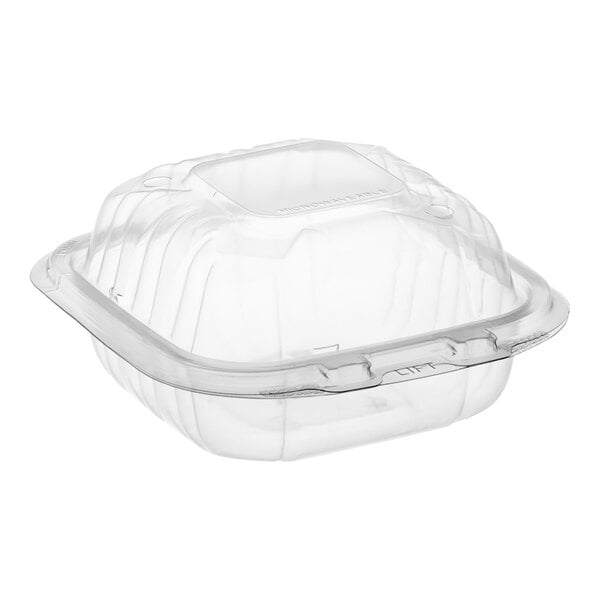 A Dart clear hinged plastic take-out container with a lid.