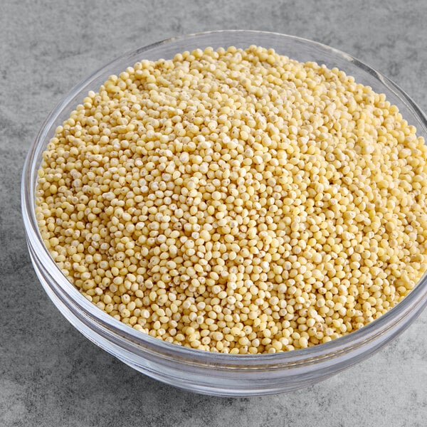 A clear bowl filled with whole grain millet.