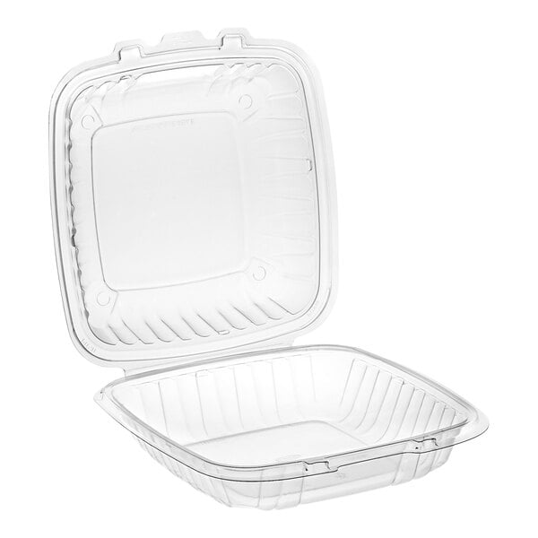 A Dart clear plastic hinged take-out container with a lid.