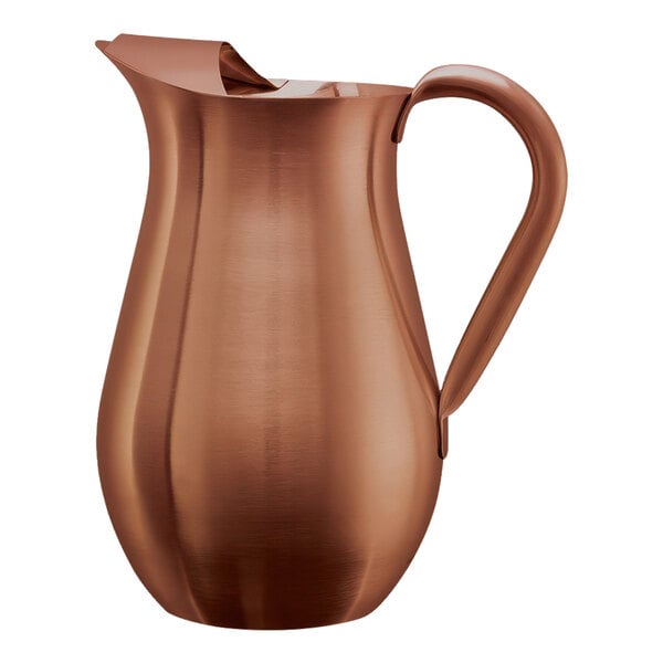 A rose gold stainless steel pitcher with a guard and handle.