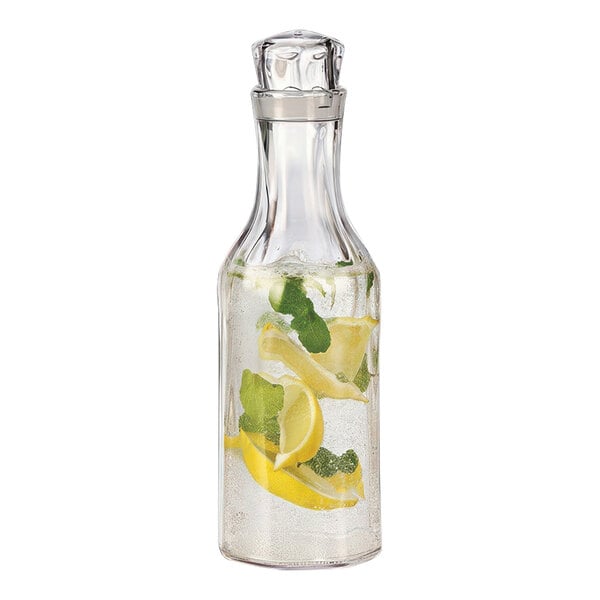 A Service Ideas SAN plastic carafe filled with water and lemon slices.