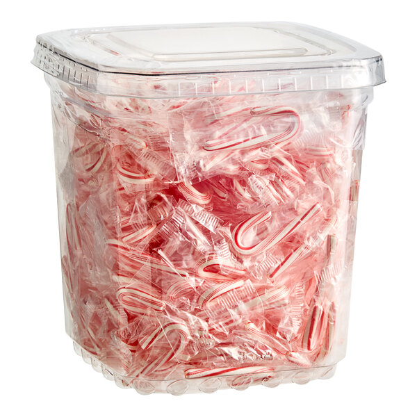 A plastic container filled with Brach's Mini Candy Canes.