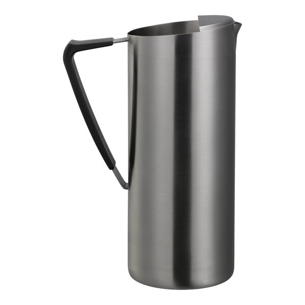 A tall, slim stainless steel pitcher with a dark handle and a spout guard.