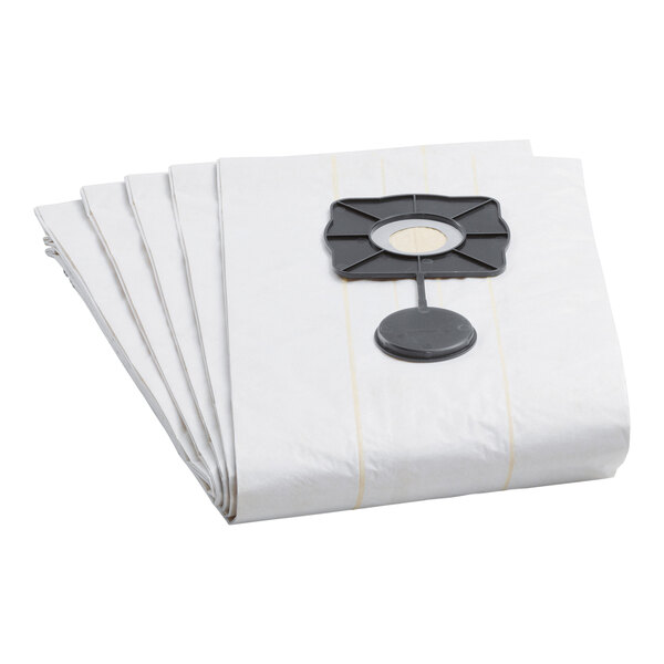 A stack of paper vacuum cleaner bags with a black plastic disc.