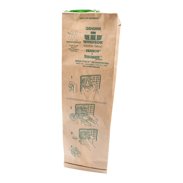 A white paper bag with brown text and a green handle with instructions for Karcher upright vacuum cleaners.