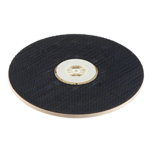 A black and white circular plastic disc with a hole in the center.