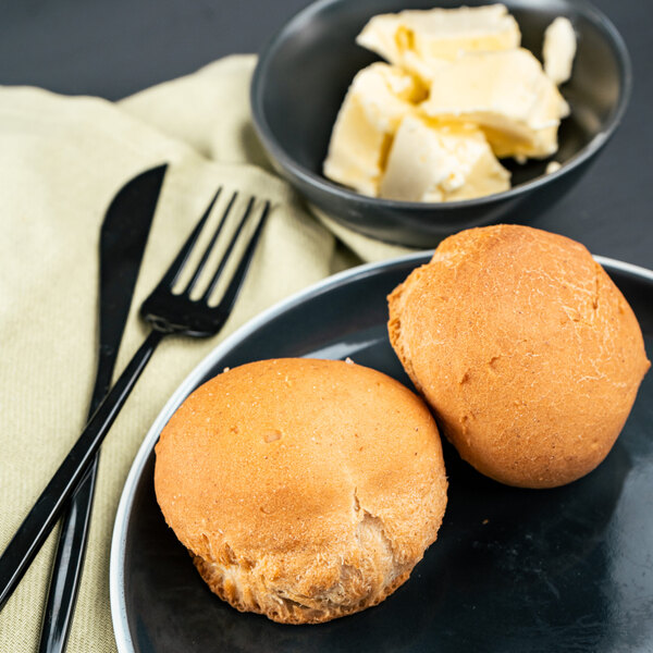 Two OMG...It's Gluten Free white dinner rolls on a plate with a fork.