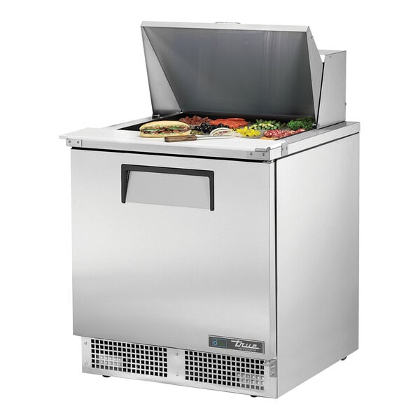 A True refrigerated sandwich prep table with one door on a counter.