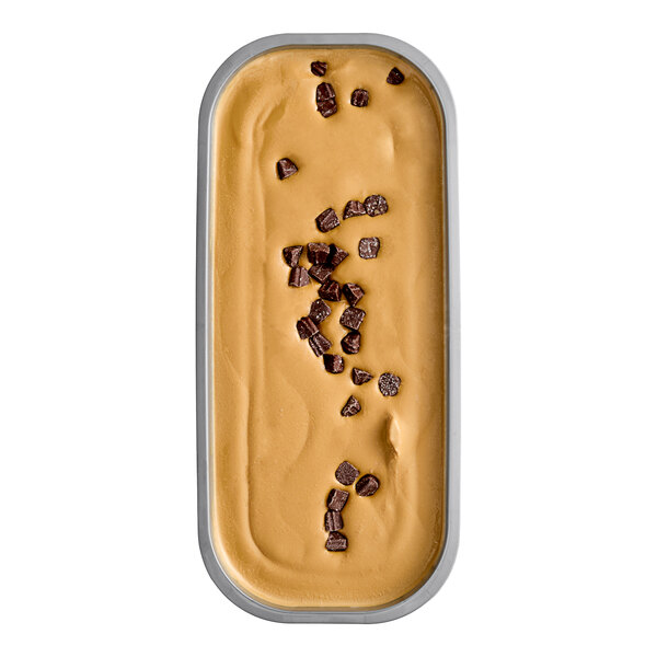 A container of Villa Dolce Argentine salted dulce de leche gelato with chocolate-dipped caramel truffles with chocolate chunks on top.