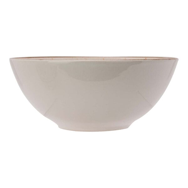 A close-up of a white Cosy & Trendy stoneware bowl with brown edges.
