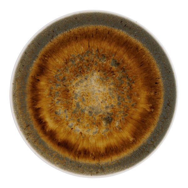A close-up of a brown Cosy & Trendy Iris porcelain coupe plate with a circular design.