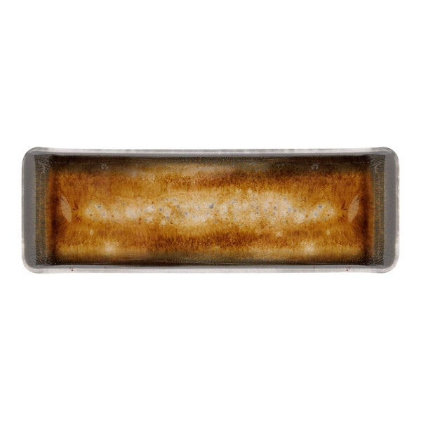 A close-up of a rectangular brown porcelain surface with white designs.