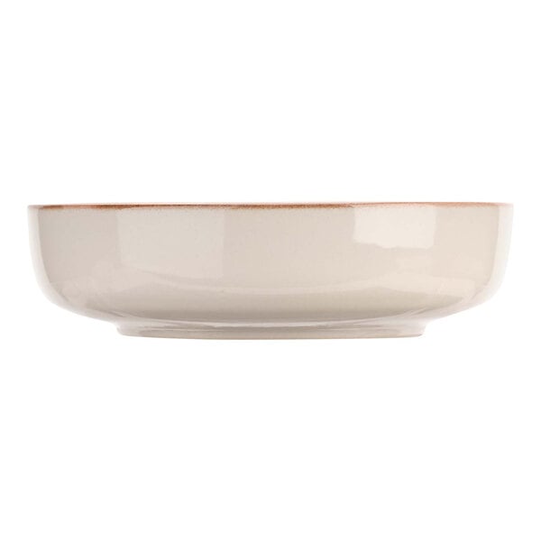 A close up of a white Cosy & Trendy stoneware bowl with a brown rim.