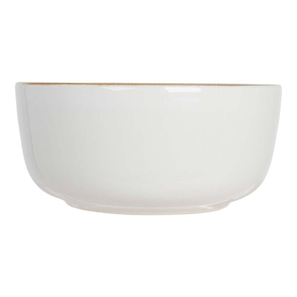 A beige stoneware bowl with a gold rim.