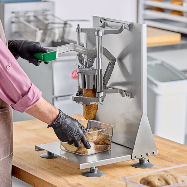 A person using a Garde Heavy-Duty 6-Wedge Potato Cutter to cut a potato.