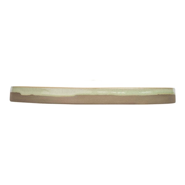 A mint green stoneware plate with a brown rim.