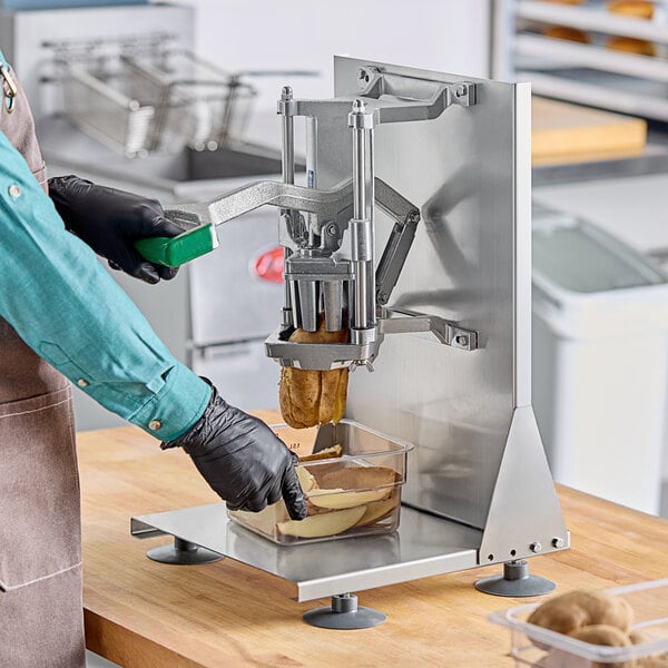 A person using a Garde countertop potato wedge cutter to make potato wedges.