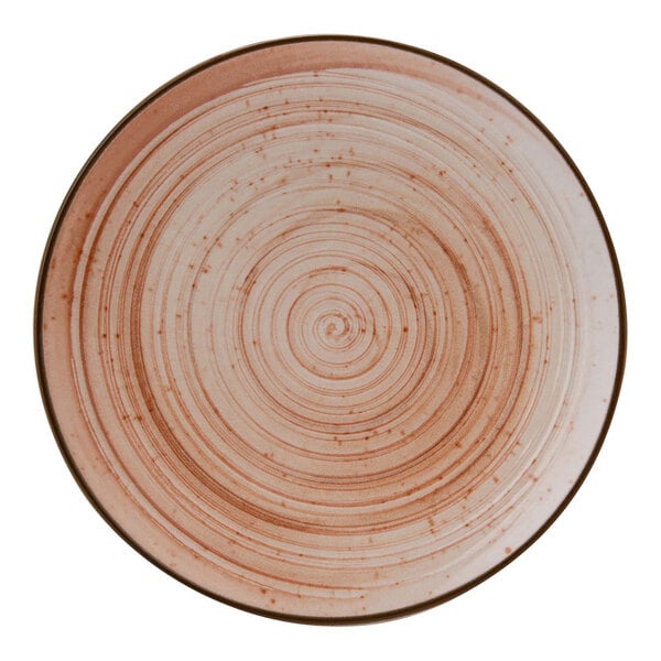 A close-up of a Cosy & Trendy terracotta stoneware coupe plate with a spiral design.