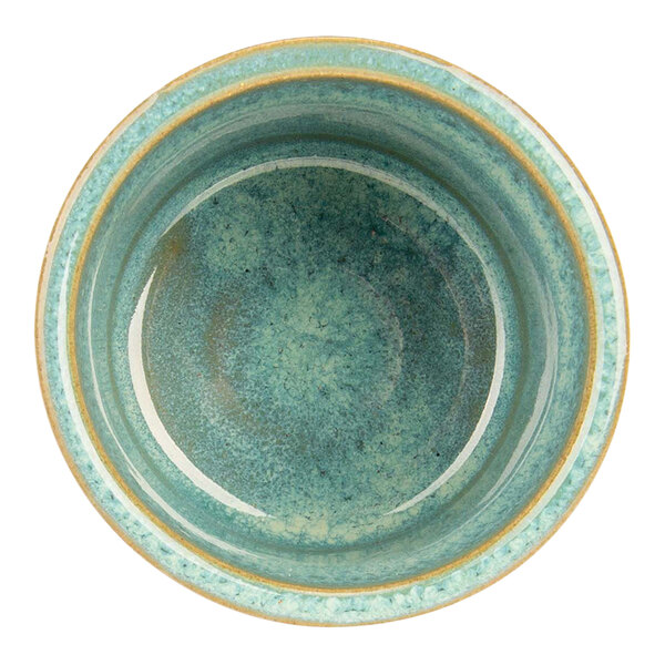 A close-up of a green Cosy & Trendy stoneware ramekin.