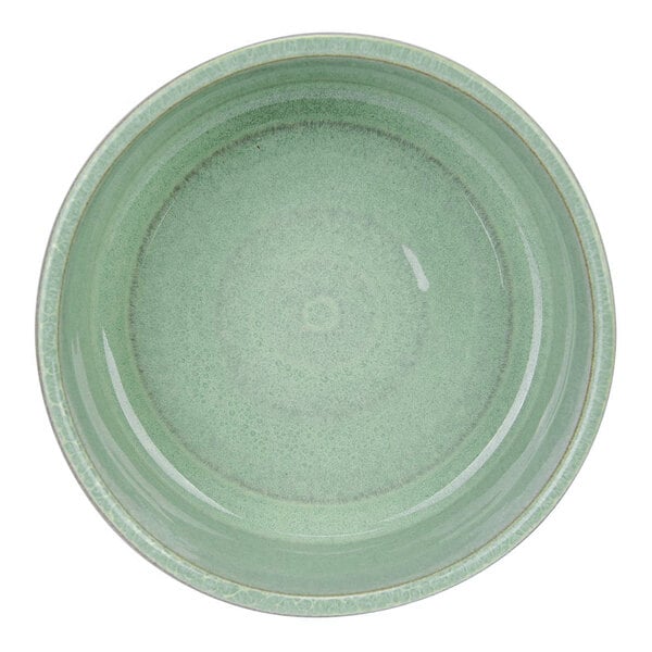A round, mint green stoneware dish with a smooth, glossy finish viewed from above.