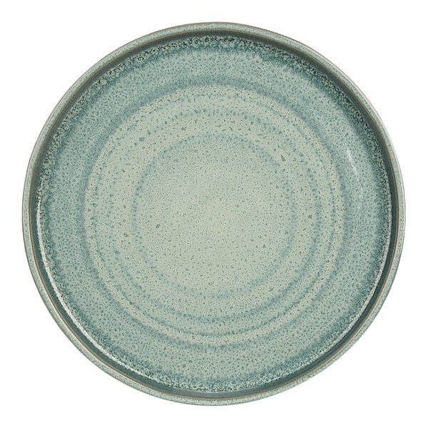 A close up of a Cosy & Trendy Ocean Green stoneware plate with speckles.