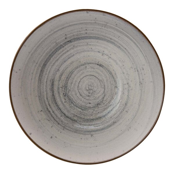 A dusty blue stoneware bowl with a spiral design on the inside.