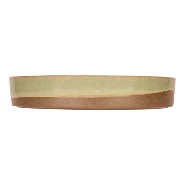 A mint green Cosy & Trendy stoneware plate with a brown rim.