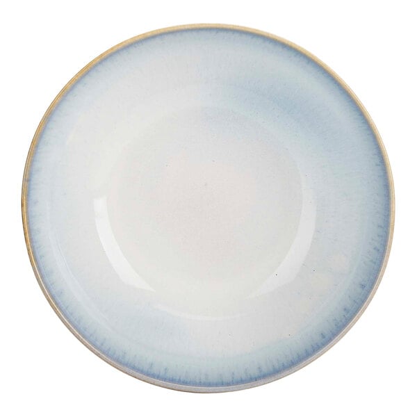 A close-up of a white porcelain serving bowl with beige and blue stripes on the rim.