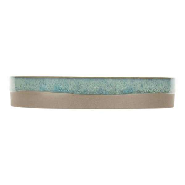 A close-up of a Cosy & Trendy blue and white speckled stoneware plate with a brown rim.