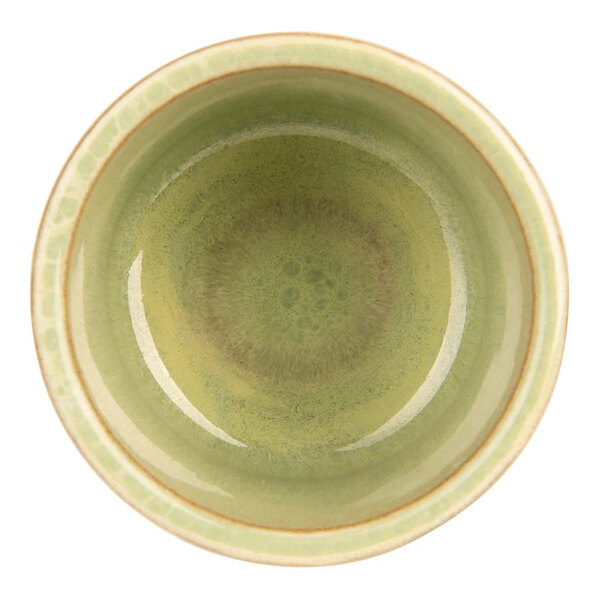 A mint green Cosy & Trendy stoneware ramekin with a brown rim.