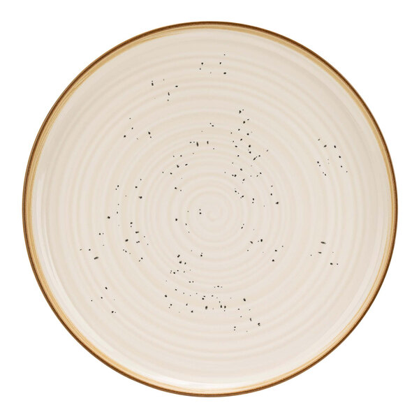 A white Cosy & Trendy stoneware coupe plate with black dots around the rim.