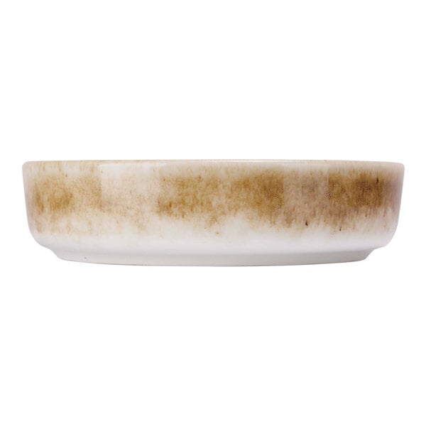A green porcelain raised plate with brown spots.
