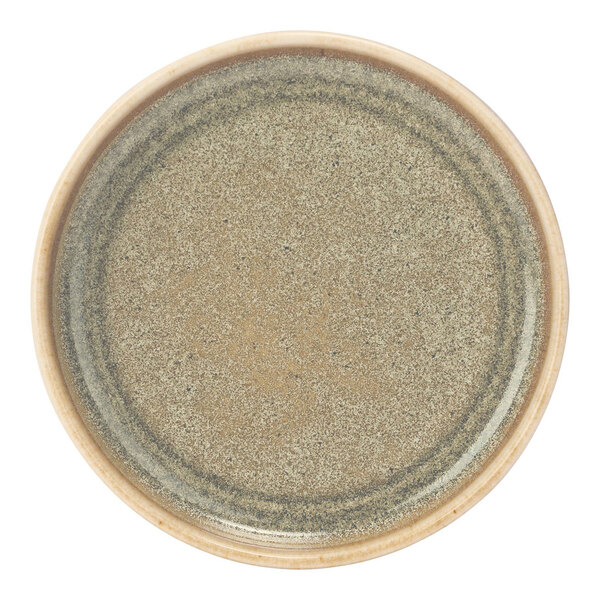 A close up of a green Cosy & Trendy Melia porcelain raised plate with a speckled design.