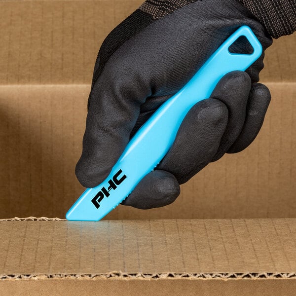 A person in black gloves using a Pacific Handy Cutter blue safety knife to cut a cardboard box.