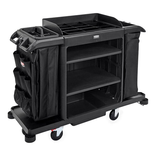 A black Rubbermaid housekeeping cart with black bags on it.