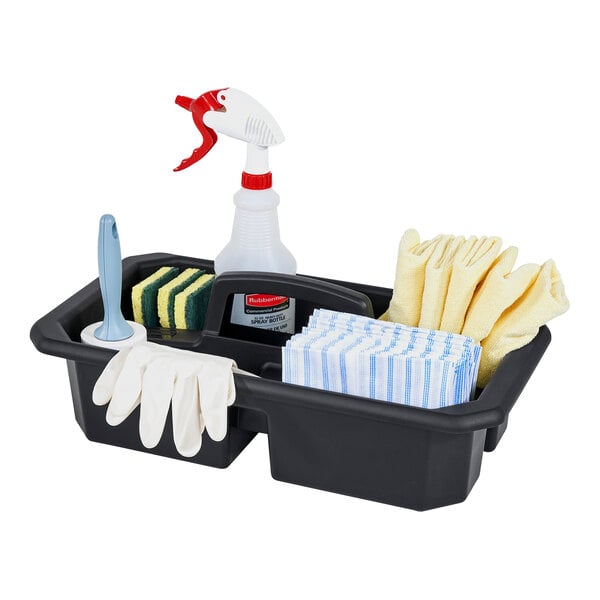 A black Rubbermaid® divided cleaning caddy on a counter with cleaning supplies inside.