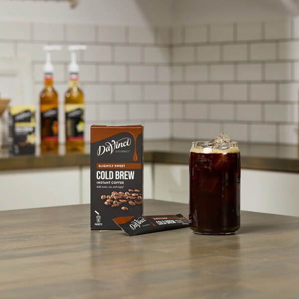 A brown and black package of DaVinci Gourmet Sweetened Cold Brew Instant Coffee next to a brown bottle.
