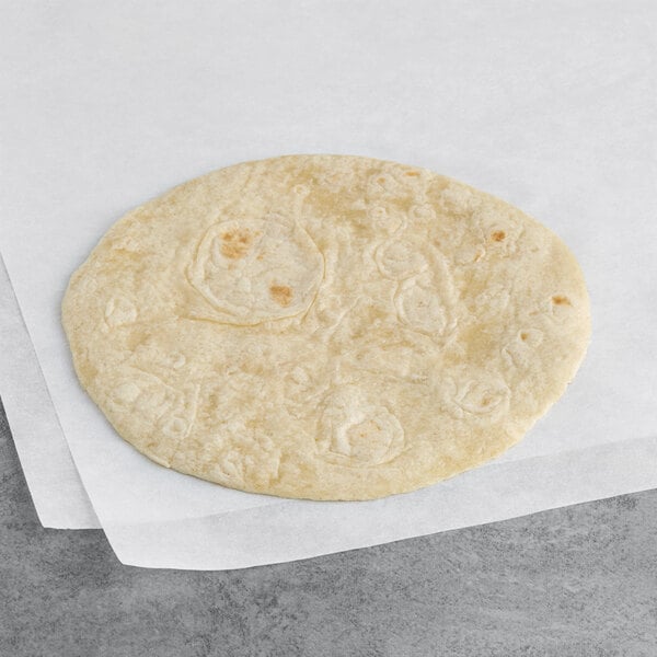 A Celia's 6" flour tortilla on white paper.