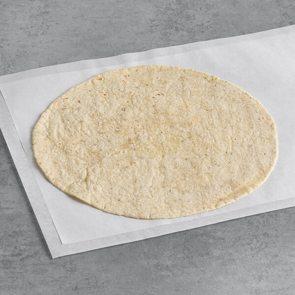 A Celia's rosemary herb garlic tortilla on a white surface.