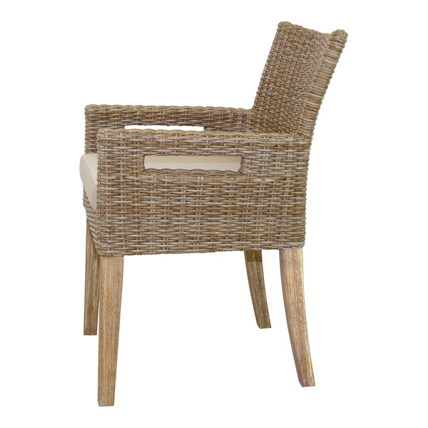 An Outdoor Interiors wicker armchair with beige cushion.