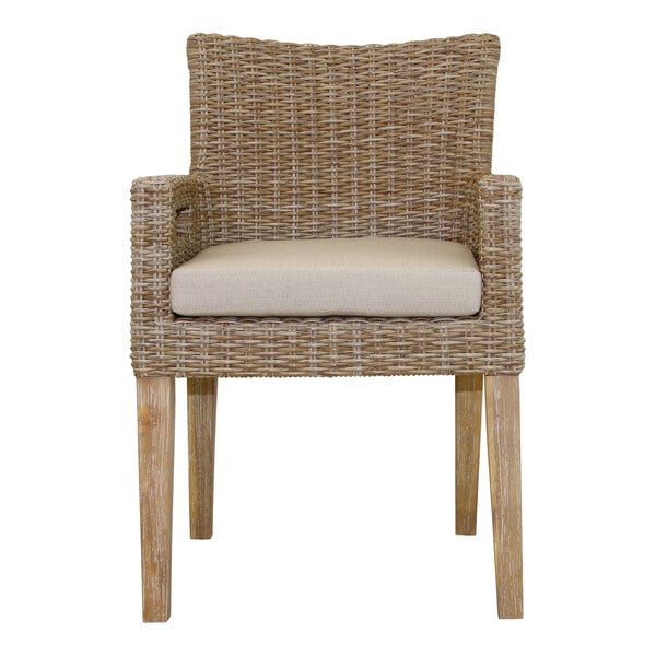 An Outdoor Interiors wicker arm chair with a white cushion.
