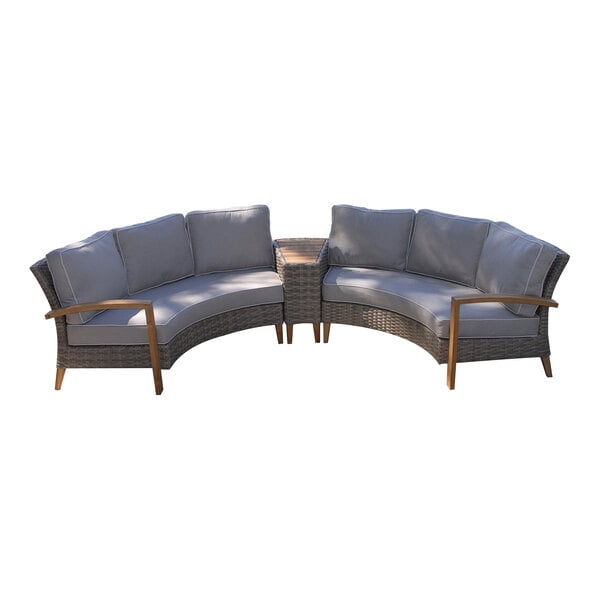 A gray and brown wicker sectional couch with wooden armrests and cushions.