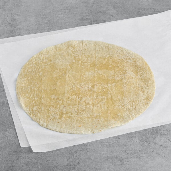 A Celia's 14" flour tortilla on a white surface.