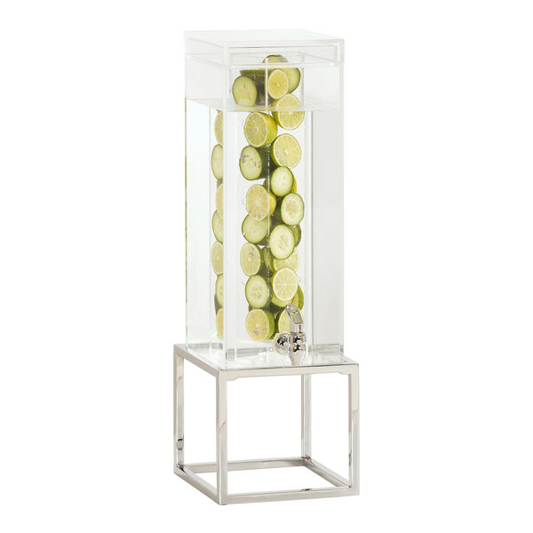 A Cal-Mil infusion beverage dispenser with limes inside on a chrome metal base.