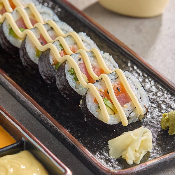 A plate of sushi rolls with Kewpie mayonnaise.