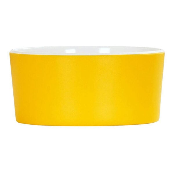 A yellow melamine bowl with a white rim.