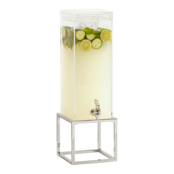 A Cal-Mil beverage dispenser with cucumber and lime slices in the ice chamber on a chrome metal base.