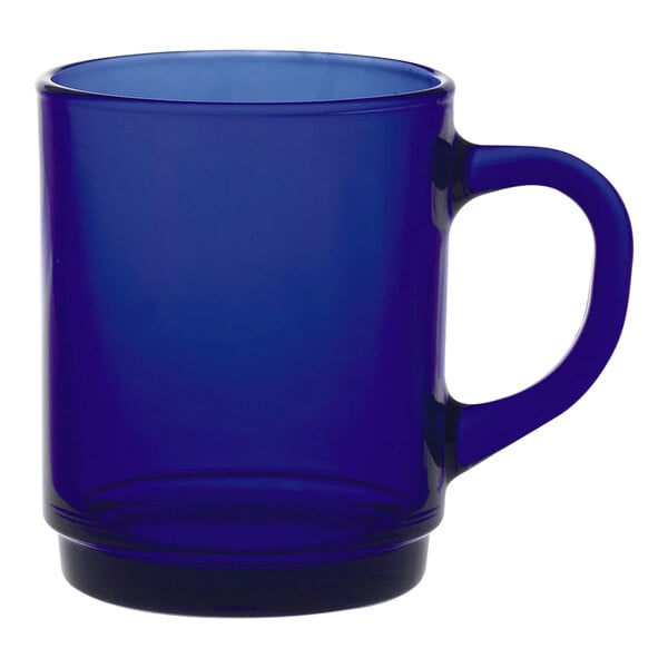 A blue Duralex glass mug with a handle.