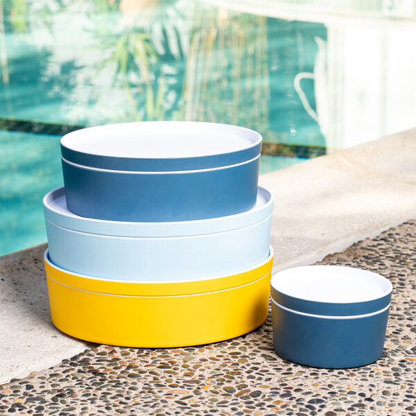 A stack of three blue and white round melamine bento boxes.
